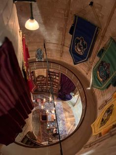 an aerial view of the inside of a building with flags hanging from it's ceiling