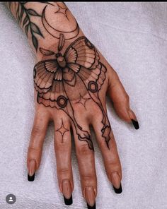 a woman's hand with tattoos on it