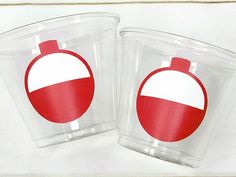 two plastic cups with red and white ornaments on them