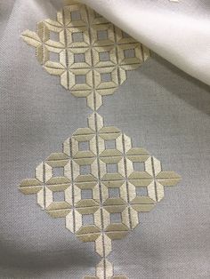 a close up view of a piece of fabric that has been stitched together with squares and circles