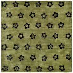 a green rug with black flowers on it