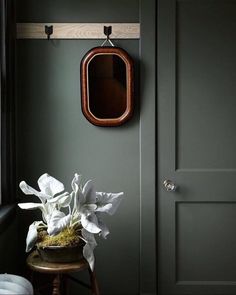 a room with green walls and white flowers