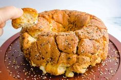 someone is holding up a piece of bread that has been baked in the shape of a bagel