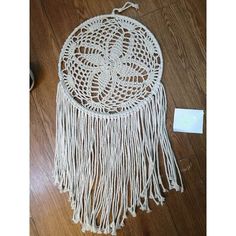 a white doily hanging on top of a wooden floor