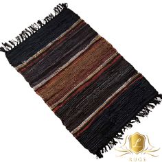 a black and brown rug with fringes on the bottom, in front of a white background