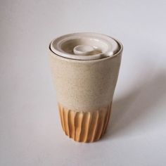 a white and brown cup sitting on top of a table