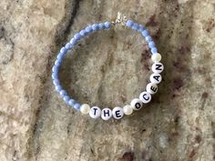 This is a beautiful hand crafted bracelet that is baby blue, and has pearls surrounding the lettering. Adjustable Blue Beaded Bracelets With Custom Name, Custom Name Blue Beaded Bracelets For Friendship, Custom Name Blue Beaded Bracelet For Friendship, Handmade Blue Name Bracelet As Gift, Handmade Light Blue Bracelets For Everyday, Custom Name Blue Beaded Bracelets As Gift, Custom Name Blue Bracelets With Round Beads, Custom Name Blue Beaded Bracelets For Gift, Blue Custom Name Beaded Bracelets As Gift