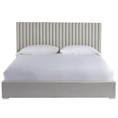 a bed with white sheets and pillows in front of a white wall behind the headboard