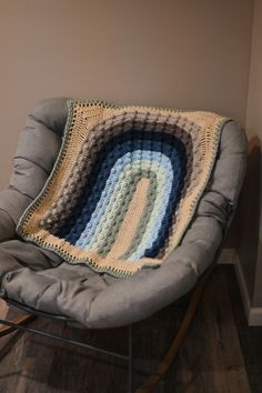 a chair with a crocheted blanket on it