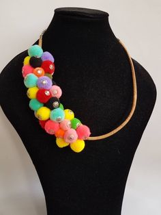 a black mannequin with multi colored beads on it