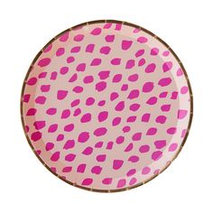 a pink and black spotted plate on a white background