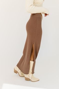 a timeless essential, this chocolate bodycon maxi skirt will transform any spring outfit idea. it features a flirty side slit, + is made with the most luxe ribbed material to stretch + snatch any silhouette. the perfect brown maxi skirt to style up or down for every occasion. mocha // maxi length, elastic waistband, side slit to thigh, ribbed paired with our rhea asymmetrical sweater top model is 5'8" + wearing a small measurements are approximate + taken while laying flat small : waist 28” leng Brown Maxi Skirt, Bodycon Maxi Skirt, Brown Maxi Skirts, Spring Outfit Idea, Knit Maxi Skirt, Asymmetrical Sweater, Small Waist, Outfit Idea, Top Model