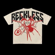 a t - shirt with the words reckless on it and a spider web in red