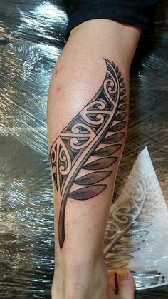 a woman's leg with a tattoo on it and an arrow in the middle