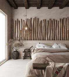 a large bed sitting in a bedroom next to a wooden wall with sticks on it