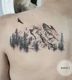 a man with a mountain tattoo on his chest and trees in the foreground, behind him is a bird