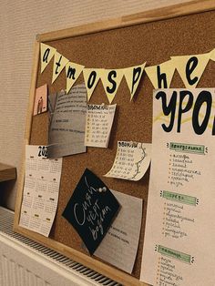 a bulletin board with some papers pinned to it