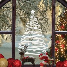 a christmas tree is seen through an open window with reindeers and presents in the foreground