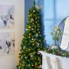 a decorated christmas tree next to a fireplace