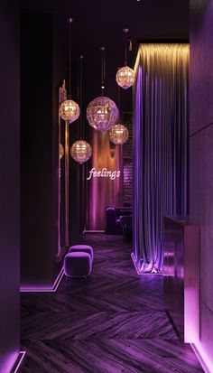 an elegant hallway with purple lighting and chandeliers