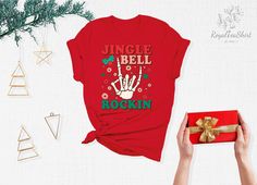 "Jingle Bell Rockin Shirt, Jingle Bell Shirt, Christmas Song, Christmas Vacation Shirt, Christmas Shirt, Christmas Shirts, Christmas Gifts Link for Backside Printing https://www.etsy.com/listing/1091793828/backside-upgrade?ref=shop_home_active_1&frs=1 - How To Order - Please, check and review all photos Choose your t-shirt color and size Click add to cart. You can go back to add more product Click \"Proceed to check out\" -PRODUCT- We use high quality soft style shirt brands. Solid colors: 100% Preshrunk Cotton, Heather Colors: 52% Cotton - 48% Poly We make black design for White, Pink, Athletic Heather, Orange and Heather Peach White design is used by other colored shirts. -CARE INSTRUCTIONS- Wash item inside out in cold water Do not bleach Do not dry clean Do not iron directly on the des Red Holiday Shirt For Gift, Red Holiday Shirt Gift, Holiday Red Shirt As Gift, Christmas Vacation Shirts, Jingle Bell, Christmas Vacation, Holiday Memories, Christmas Song, Star Shirt