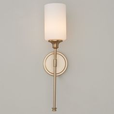 a wall light with a white shade on it