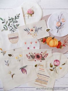 several embroidered napkins with flowers and leaves on them, all laid out in different patterns