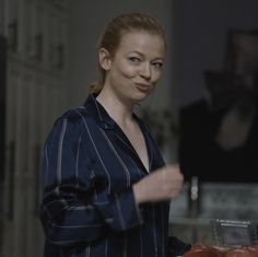 a woman standing in front of some food