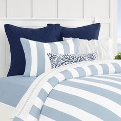 a bed with blue and white striped sheets