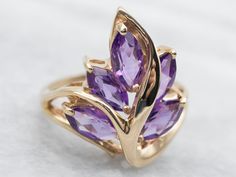 "Put the perfect finishing touch on your look with this stunning marquise cut amethyst leaf ring! The unique shape adds a touch of personality, while the yellow gold ensures that this jewelry piece stands out. Add a bit of sparkle to any outfit! Metal: 10K Yellow Gold Gem: 5 Amethyst totaling 2.50 Carats Gem Measurements: 4.3 x 7.9 mm, Marquise Cut Ring Size: 7.25 Marks: \"CI 10K\" Stamped on the inside band SKU #: A34969 Each piece has been identified and graded by a Graduate Gemologist who has Amethyst Ring Gold, Yellow Gold Amethyst Ring, Botanical Ring, Amethyst Ring Vintage, Marquise Cut Rings, Gold Amethyst Ring, Amethyst Gem, Purple Band, Leaf Ring