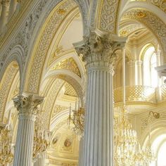 an ornate building with columns and chandeliers