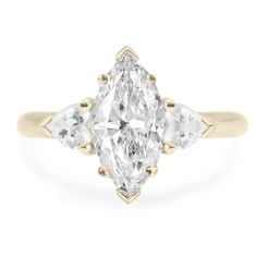 a three stone diamond ring with two pear shaped diamonds