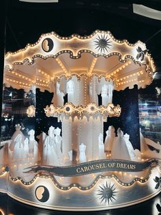 a carousel with white lights and decorations on display