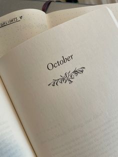 an open book with the word october written on it's cover in black ink