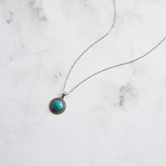 Step into the elegance of a bygone era with our Vintage Turquoise Oval Necklace , a stunning piece that marries timeless design with exquisite craftsmanship. This necklace features an intricately detailed oval pendant, crafted from 925 Sterling Silver and adorned with a striking turquoise centerpiece. The vibrant turquoise, with its signature blue-green hue and natural veining, is surrounded by delicate scrollwork and sparkling zircon accents, adding a touch of refined brilliance to the piece.   The Vintage Turquoise Oval Necklace  elevates your ensemble with its unique blend of classic beauty and contemporary sophistication, making it a must-have addition to any jewelry collection. DETAILS Plating: Oxide Silver Materials: 925 Sterling Silver , Turquoise, Zircon Measurements: Length: 17.71 Oxidized Turquoise Oval Jewelry, Vintage Turquoise Necklace With Oxidized Finish As Gift, Turquoise Round Locket Jewelry, Round Turquoise Locket Jewelry, Turquoise Necklace With Oxidized Finish For Gift, Turquoise Engraved Round Pendant Necklace, Bohemian Engraved Turquoise Necklaces, Elegant Blue Necklace With Coin Pendant, Engraved Turquoise Necklace With Round Pendant