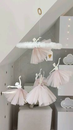 three ballerinas are hanging from the ceiling