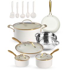 a white and gold cookware set is shown with utensils on the side