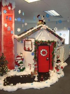 an office cubicle decorated for christmas with snowmen and decorations on the front door