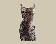 "Vintage 1990s Moschino cheetah print bodycon dress. Sleeveless, with a slightly lower back neckline. Comes to mid-thigh length. No brand tag but see Moschino label further down the inside of the garment. Quality Control: it is in good vintage condition; please note fabric pulls throughout the garment. At the centre back of the garment, the front left near the hem and the back right seam, near the hem.  Measurements: Listed Size: UK14 Chest: 30.5\" Waist: 26.5\" Hip: 34\" Length: 27\"" Animal Print Mini Dress, Dress Low Back, Moschino Dress, Cheetah Dress, Printed Bodycon Dress, Brand Tags, Dress Sleeveless, Vintage Silk, Low Back