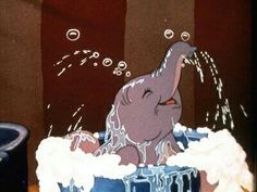 an elephant in a bathtub with bubbles coming out of it