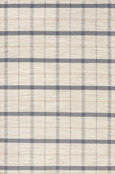 a white and grey plaid fabric with some black lines on it, as well as an area rug