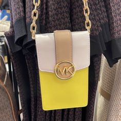 Michael Kors Carmen Small Color-Block Faux Leather Phone Crossbody Bag Sunshn Color: Sunshine Multi / Yellow Crossbody Bag Faux Saffiano Leather 88.92% Coated Canvas/11.08% Polyester Trim: 100% Polyurethane Gold-Tone Hardware 4.25”W X 7”H X 1.25”D Interior Details: 3 Card Slots Lining: 100% Polyester Snap Fastening Imported Yellow Crossbody Phone Bag With Adjustable Strap, Michael Kors Yellow Travel Shoulder Bag, Michael Kors Yellow Shoulder Bag For Travel, Yellow Travel Crossbody Phone Bag, Yellow Crossbody Phone Bag For Travel, Yellow Crossbody Phone Bag With Cell Phone Pocket, Michael Kors Yellow Shopping Bag, Yellow Michael Kors Leather Shoulder Bag, Michael Kors Yellow Leather Shoulder Bag