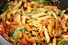 a pot filled with pasta and vegetables on top of a stove