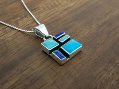 We love all the colors our artists put in our Mosaic Collection. Delivered on an 18" sterling silver faceted bolitas chain (pictured). Weight: 8.5 grams Unique Blue Rectangular Pendant Jewelry, Unique Blue Rectangular Pendant Necklace, Blue Rectangular Pendant Necklace, Unique Blue Necklace With Inlay, Rectangular Sterling Silver Jewelry With Inlay, Blue Sterling Silver Necklace With Inlay, Unique Blue Necklace With Polished Finish, Modern Blue Pendant Jewelry, Polished Multicolor Jewelry For Gift