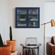 a living room with a couch, coffee table and two glass doors on the wall