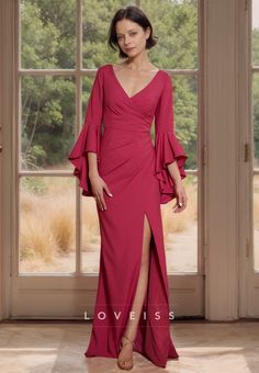 a woman standing in front of a window wearing a red dress with ruffle sleeves