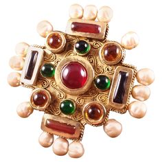 Rare, enormous Maison Gripoix for Chanel Byzantine Cruciform cuff bracelet. The symmetrical squared oversized cruciform cuff is composed of ruby, emerald, amythest and citrine poured glass pate de verre enamel cabochons which decorate the central motif. Hand made faux baroque pearls decorate this iconic byzantine Chanel cuff bracelet. Victoire de Castellane for Chanel. Excellent Condition, Signed Chanel. Likely a runway piece because of scale. Motif 4" x 4". Cuff is slightly malleable. Coco Chanel 1920s, Chanel Cuff Bracelet, Chanel Cuff, Chanel Shopping, Victoire De Castellane, Byzantine Jewelry, Chanel Brooch, Maltese Cross, Ruby Emerald