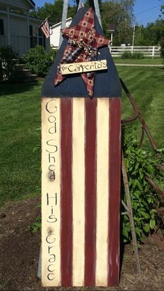 an american flag shaped mailbox in the yard