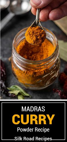 a person spooning curry into a jar filled with powdered vegetables and spices on a table