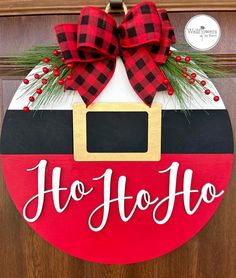 a christmas door hanger with the word ho hoo on it and a bow